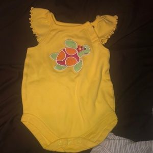 yellow embroidered turtle onesie